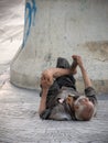 A old man is homeless or beggar sleeping beside street Royalty Free Stock Photo