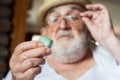 Old man inspecting a precious stone Royalty Free Stock Photo