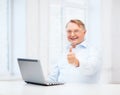 Old man with laptop computer showing thumbs up Royalty Free Stock Photo