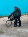 Old man life along with his bike