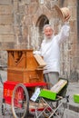 An old man with long white bread plays his street organ. Royalty Free Stock Photo