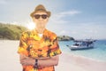 Confident old man wearing sunglasses on the beach Royalty Free Stock Photo