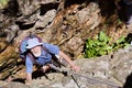 Old man looks up while climbing