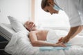 Old man lying in hospital bed during medical procedure Royalty Free Stock Photo