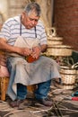Old man making wicker handles for craft wicker baskets. Latin and Hispanic Culture