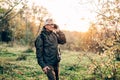 Old man man using smartphone in forest Royalty Free Stock Photo