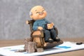 Old man model and coins on financial documents