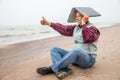 Old man with notebook on beach