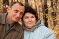 Old man and old woman in autumnal forest Royalty Free Stock Photo