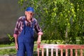 Old man painting bench in garden Royalty Free Stock Photo