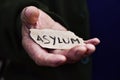 Old man with a paper with the word asylum Royalty Free Stock Photo