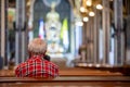 Old man parishioner sitting in church