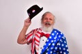 Old man in patriotic costume waving his hat