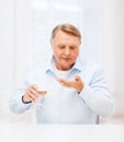 Old man with pills ang glass of water Royalty Free Stock Photo