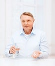 Old man with pills ang glass of water Royalty Free Stock Photo