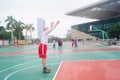 The old man is playing basketball as a leisure sport