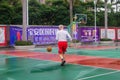 The old man is playing basketball as a leisure sport