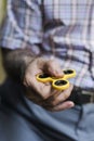 Old man playing with a fidget spinner Royalty Free Stock Photo
