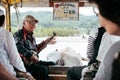 Old man playing Sanshin or Shamisen on Iriomote buffalo cart tour, Okinawa Royalty Free Stock Photo