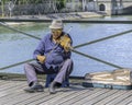 Old man playing violin at Pont des Arts - The Love Lock Bridge. Royalty Free Stock Photo