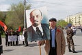 Old man with portrait of the Soviet founder Vladimir Lenin takes part in the May day demonstration in Volgograd