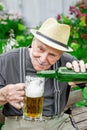 old man pours beer from a bottle into a beer glass. Royalty Free Stock Photo