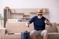 Old man preparing for trip at home