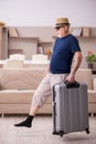 Old man preparing for trip at home