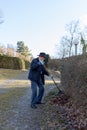 Old man raking fallen leaves in the garden, senior man gardening Royalty Free Stock Photo