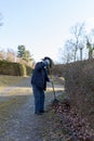 Old man raking fallen leaves in the garden, senior man gardening Royalty Free Stock Photo