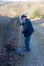 Old man raking fallen leaves in the garden, senior man gardening Royalty Free Stock Photo