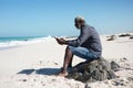 Old man reading book at the beach Royalty Free Stock Photo
