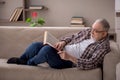 Old man reading book at home Royalty Free Stock Photo