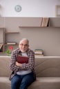 Old man reading book at home Royalty Free Stock Photo