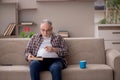 Old man reading book at home Royalty Free Stock Photo