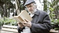 Old man reading book in the park Royalty Free Stock Photo