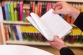 An Old Man Reading A Book And Turning page, In The Library. Royalty Free Stock Photo