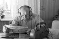 Old Man Reading Tabloid While Listening Music