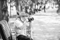 old man relax in park. life during coronavirus lockdown. enjoy the beauty. fear of illness. photographer with camera on