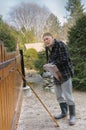 Old man repairing a gate