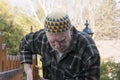 Old man repairing a gate