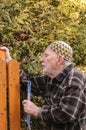 Old man repairing a gate