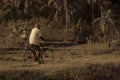 Old man riding bicycle in rural place Royalty Free Stock Photo