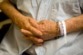 Old man's hands folded with hospital wristband Royalty Free Stock Photo