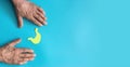 old man's hands and stomach symbol cut out of yellow paper on a blue background, banner, copyspace . stomach Royalty Free Stock Photo