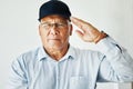 Old man, salute and portrait for veteran soldier on white background for gratitude, pride or respect. Elderly male, army