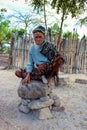Old man from Sawu island sitting on the stone, Indonesia Royalty Free Stock Photo