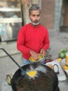 An old man Sell Bread Pakoda and Samosa On road for His Living In Winter . Royalty Free Stock Photo