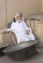 Old man selling old copper cooking dishes