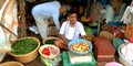 An old man selling fresh vegetables at agriculture produce market Royalty Free Stock Photo